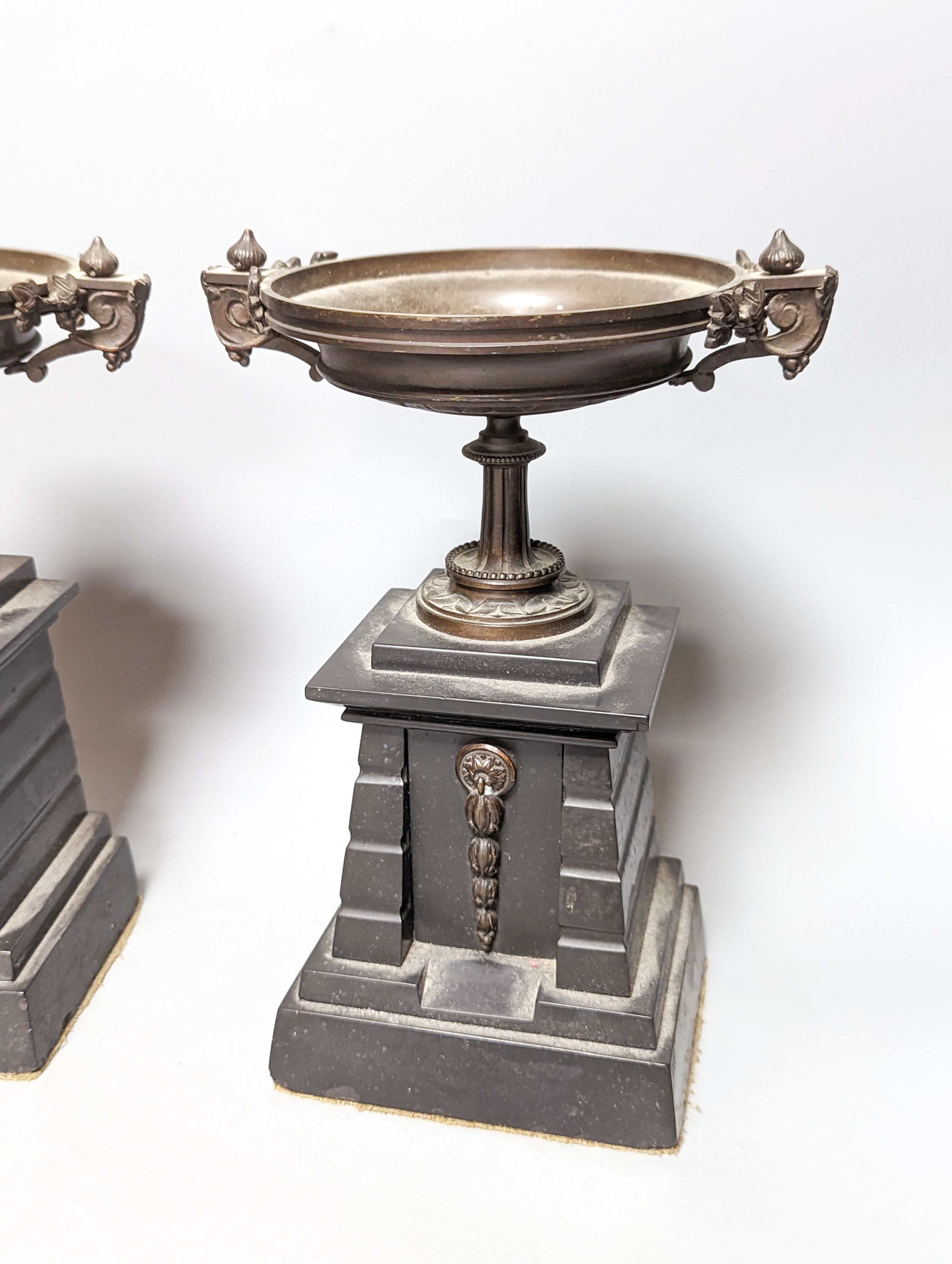 A pair of bronze tazzas on architectural slate bases, c.1900, together with a third, associated piece (3) 25cm